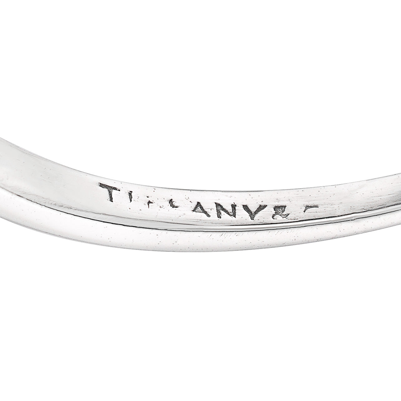 Signature on shank of Art Deco Tiffany platinum and diamond navette shaped ring on white background