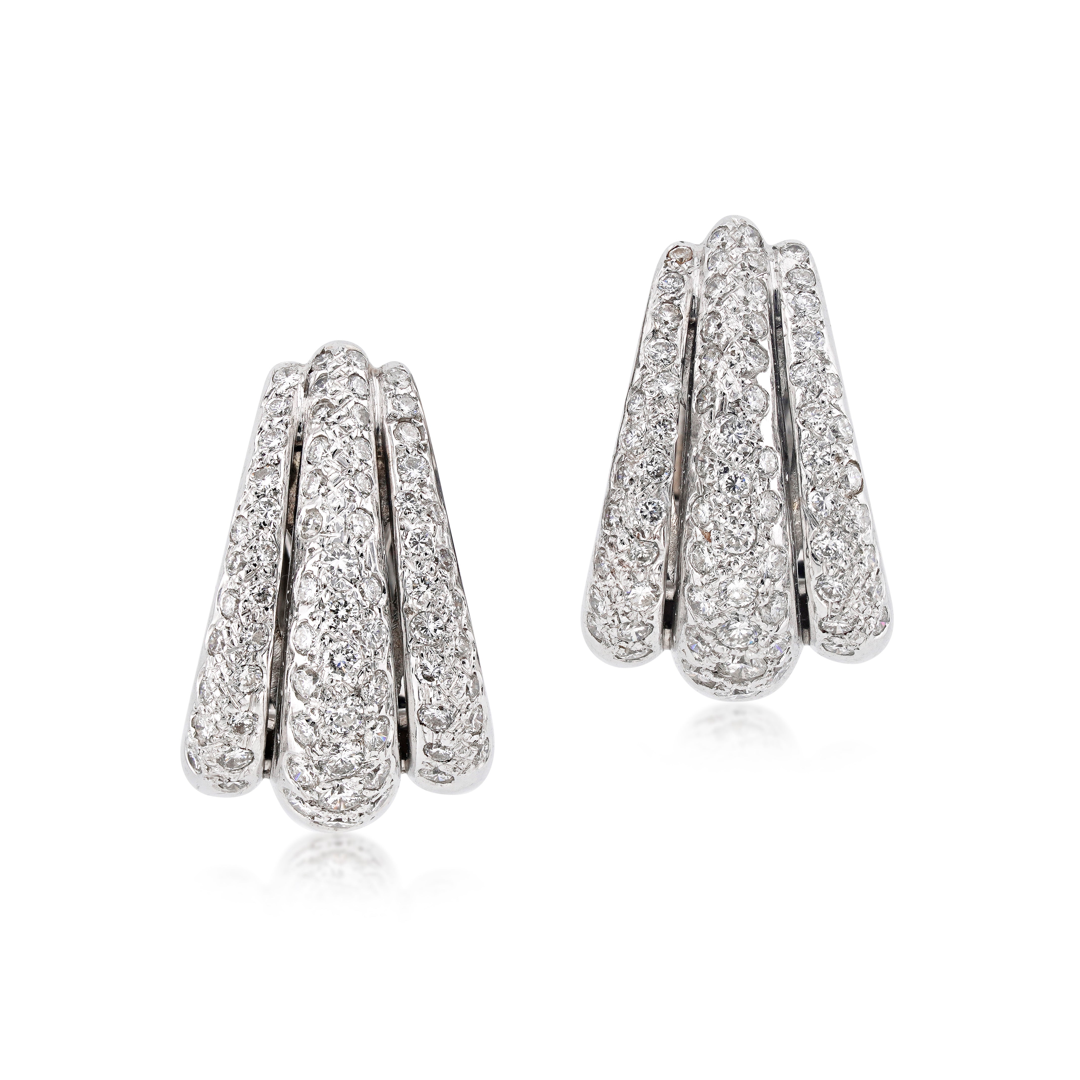 vintage 18kt white gold and diamond hoops on white background