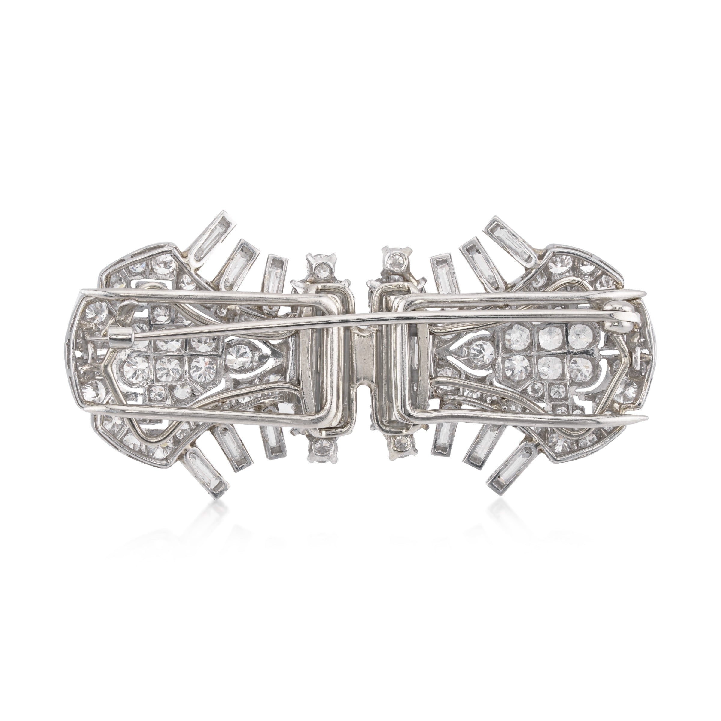back side of vintage Cartier platinum and diamond double clips as single brooch on white background