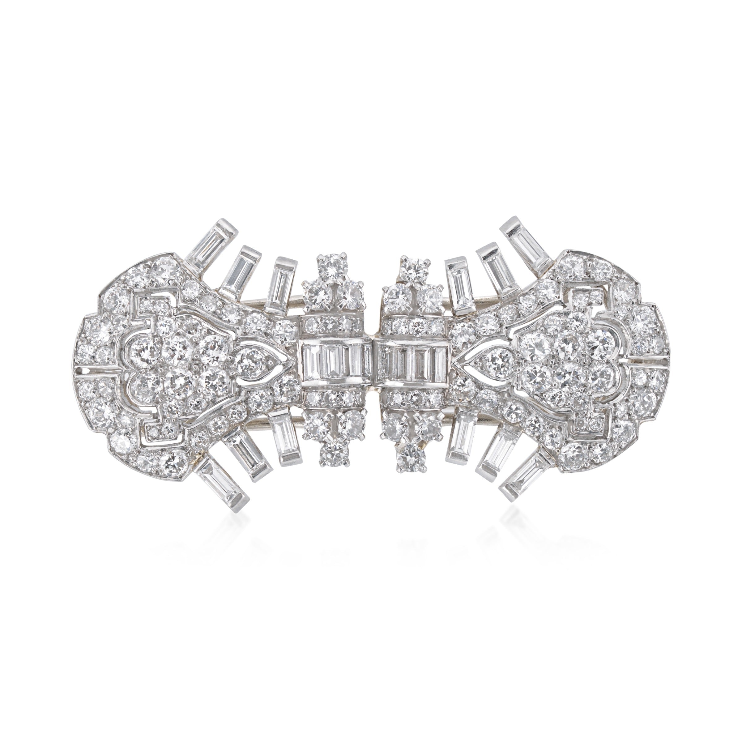vintage Cartier platinum and diamond double clips as single brooch on white background