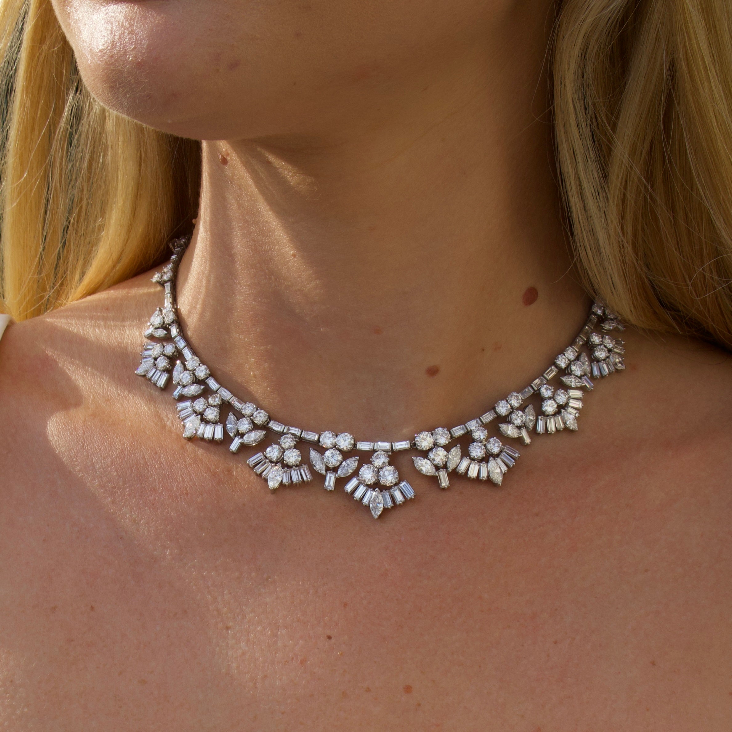 Vintage platinum and diamond mid-century necklace on neck with blond hair