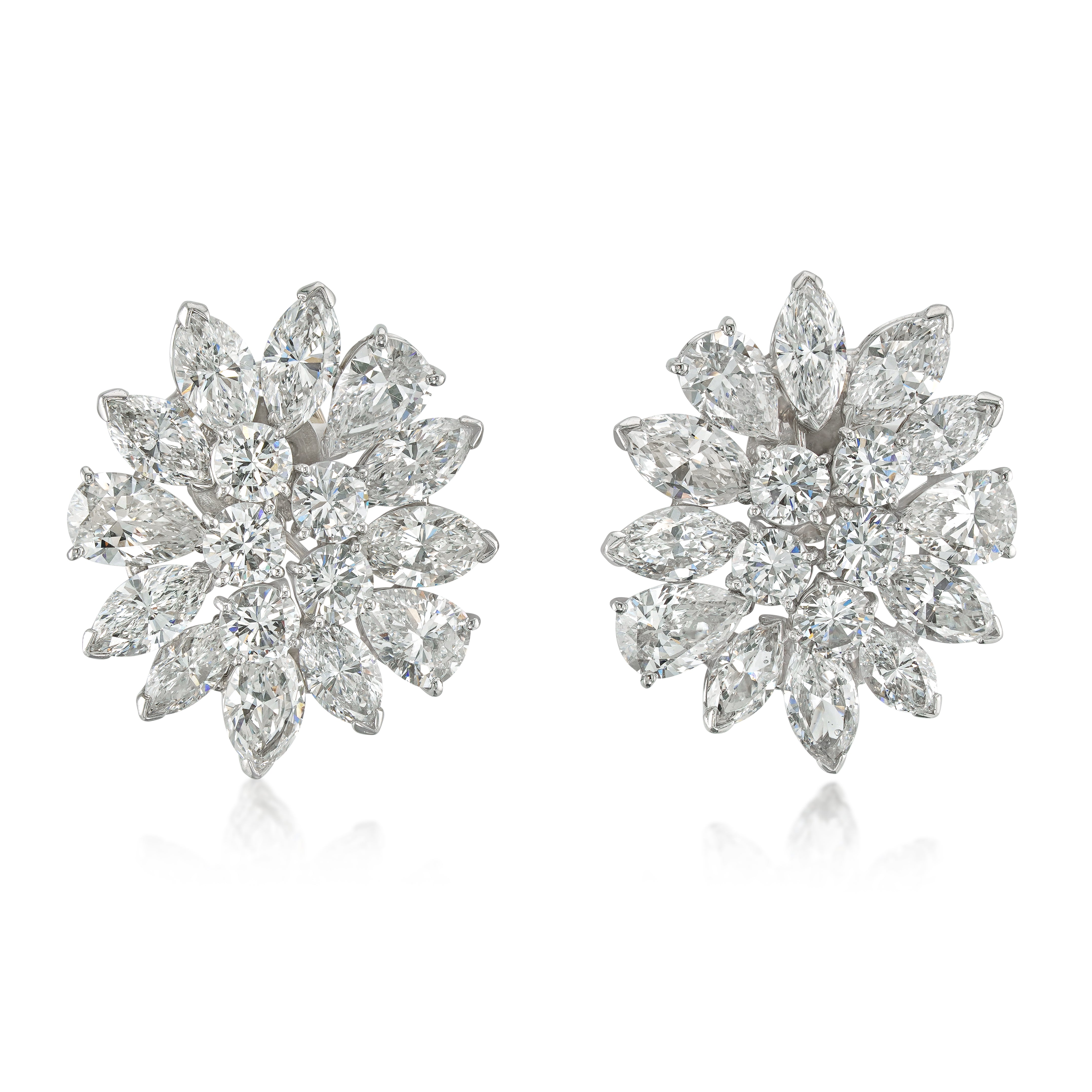 Pair of platinum diamond cluster earrings on white background
