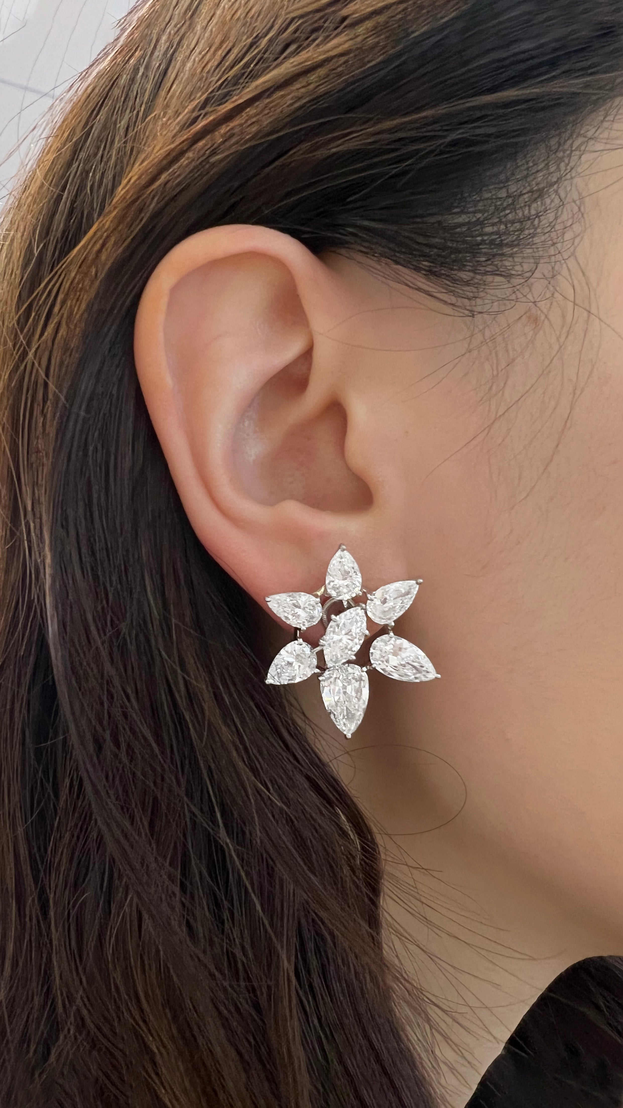 vintage cartier platinum and diamond cluster earrings on ear