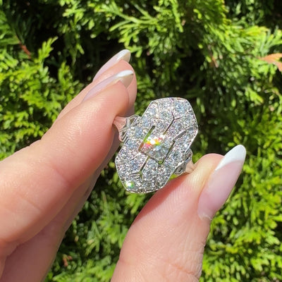 Video of Art Deco Tiffany platinum and diamond navette shaped ring osparkling in sunshine in hand