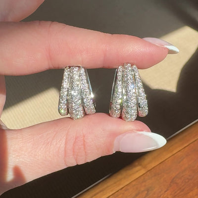 Video of vintage 18kt white gold and diamond hoops shining in the sun