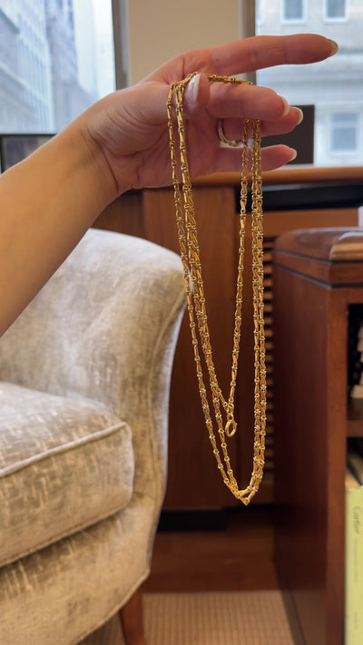 Video of woman holding 18kt yellow gold link chain necklace