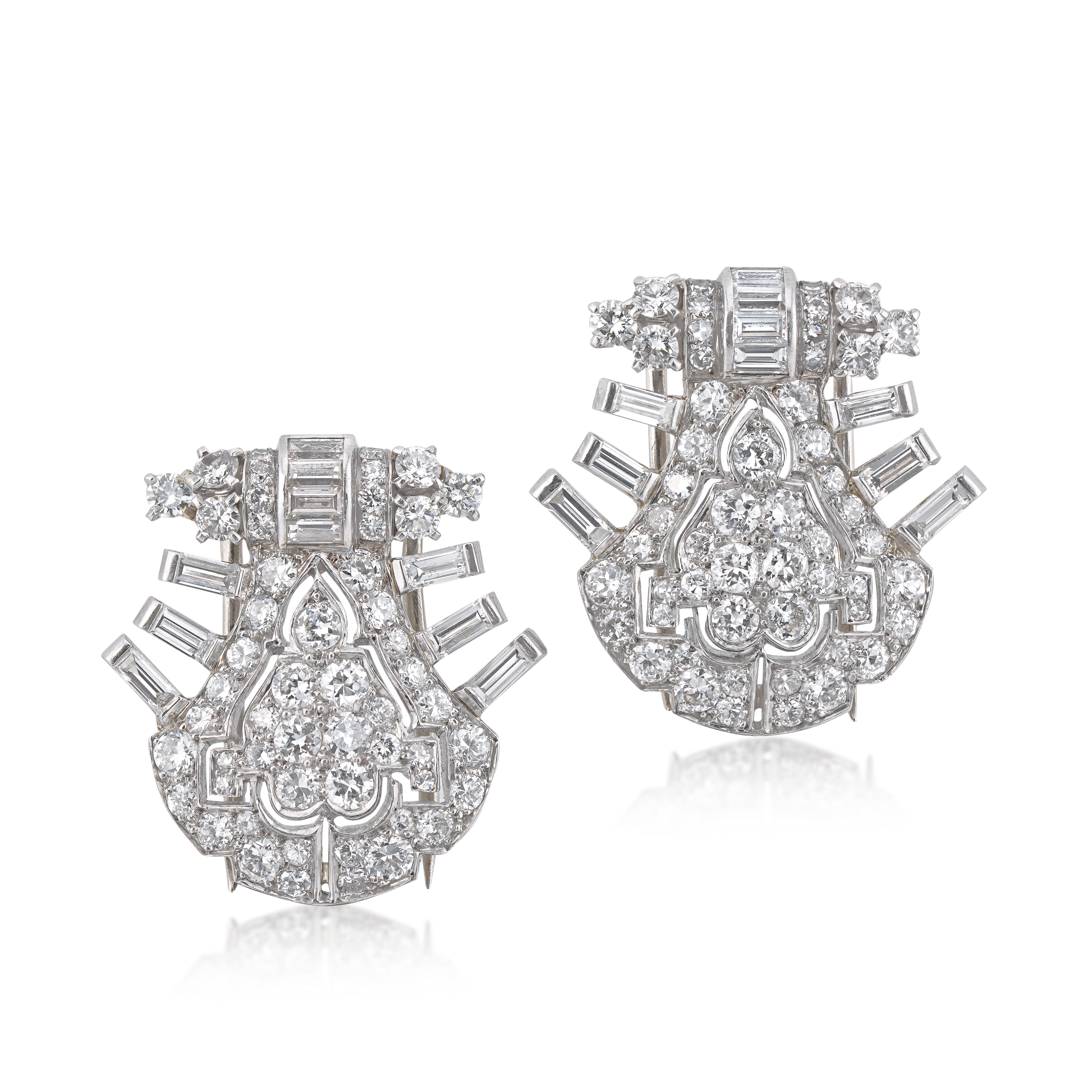 vintage cartier platinum and diamond double clips seperate on white background